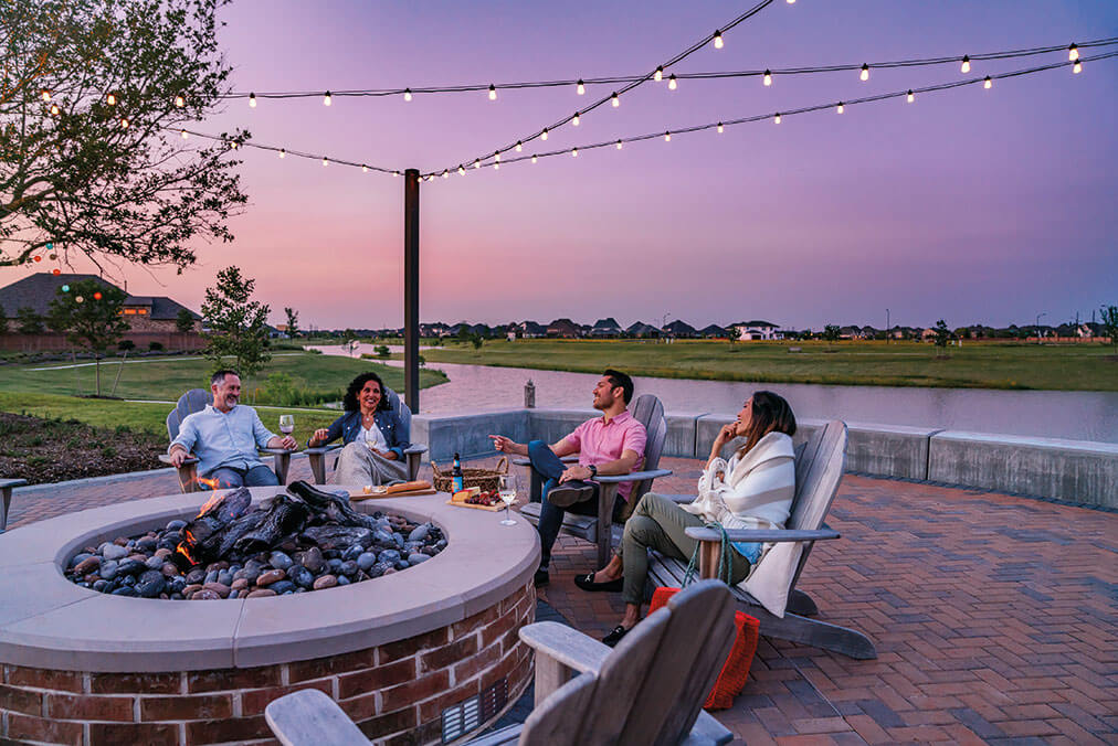 Residents sitting fireside at Elyson community in Katy, TX